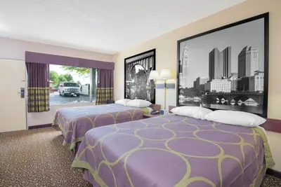 a hotel room with two beds and a large picture at Super 8 by Wyndham Ashland in Ashland