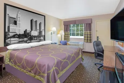a hotel room with a bed and a flat screen tv at Super 8 by Wyndham Ashland in Ashland