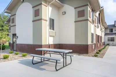 a picnic table in front of a building at Super 8 by Wyndham Weston WV in Weston