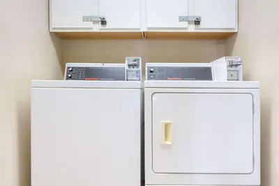 two refrigerators sitting next to each other in a room at Super 8 by Wyndham Weston WV in Weston