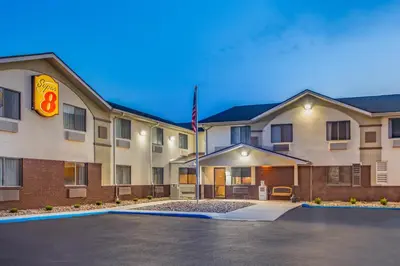 a hotel with a parking lot in front of it at Super 8 by Wyndham Weston WV in Weston