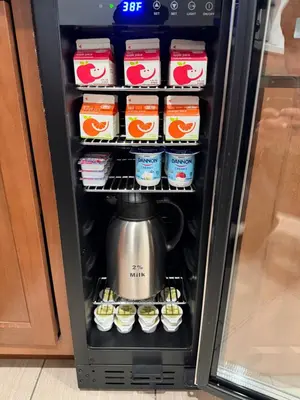a refrigerator with a tea kettle and cupcakes at Baymont by Wyndham Findlay in Findlay