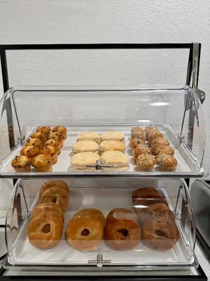 a display case filled with lots of different types of donuts at Baymont by Wyndham Findlay in Findlay