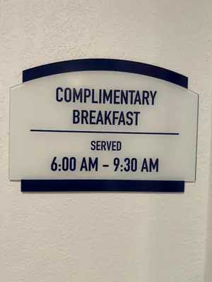 a sign for aurrencyurrencybreakfast on a wall at Baymont by Wyndham Findlay in Findlay