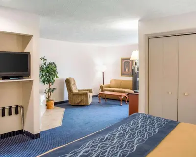 a hotel room with a bed and a living room at Comfort Inn Piketon near Fairgrounds in Piketon