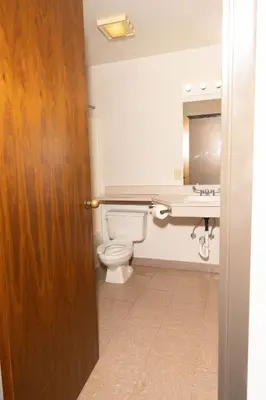 a bathroom with a toilet and a sink at Lafayette Inn in Moundsville