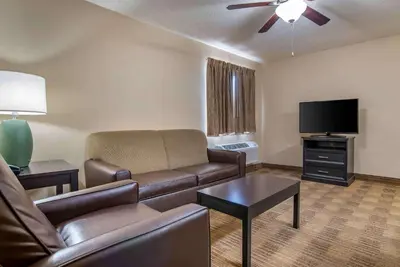 a living room with a couch and a flat screen tv at Extended Stay America Suites - Fort Wayne - North in Fort Wayne