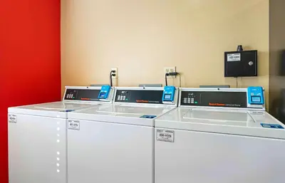 a row of washing machines in a room at Extended Stay America Suites - Fort Wayne - North in Fort Wayne