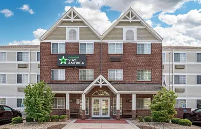 a large brick building with a sign on it at Extended Stay America Suites - Cincinnati - Blue Ash - Reed Hartman in Blue Ash