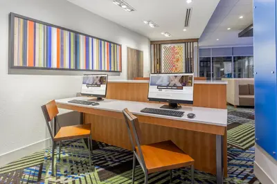 an office with two computer monitors on a desk at Holiday Inn Express & Suites - Florence - Cincinnati Airport by IHG in Florence
