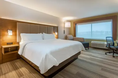 a hotel room with a large bed and a window at Holiday Inn Express & Suites - Florence - Cincinnati Airport by IHG in Florence