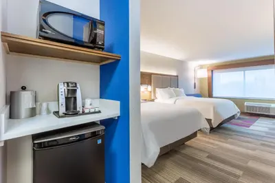 two pictures of a hotel room with a bed and a tv at Holiday Inn Express & Suites - Florence - Cincinnati Airport by IHG in Florence