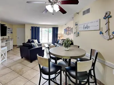 a dining room and living room with a table and chairs at Put-in-Bay Poolview Condo #2 in Put-in-Bay
