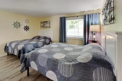 a bedroom with two beds and a window at Put-in-Bay Poolview Condo #2 in Put-in-Bay