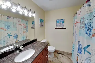 a bathroom with a sink and a toilet and a shower at Put-in-Bay Poolview Condo #2 in Put-in-Bay