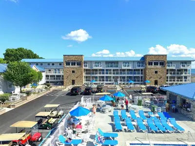 an aerial view of a resort with chairs and umbrellas at Put-in-Bay Poolview Condo #2 in Put-in-Bay