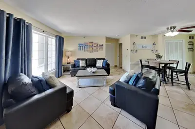 a living room with two couches and a table at Put-in-Bay Poolview Condo #2 in Put-in-Bay