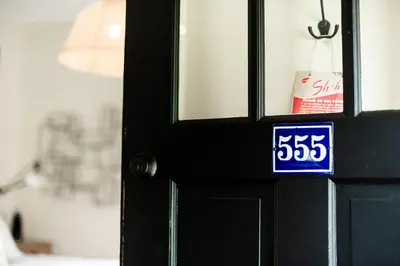 a black door with a blue sign on it at Studio 555 in Granville