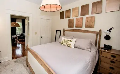 a bedroom with a bed and a desk and a lamp at Studio 555 in Granville