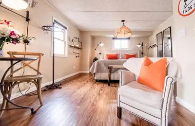 a bedroom with a bed and a couch and a chair at The Loft in Granville