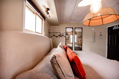a room with a bed with pillows and a window at The Loft in Granville