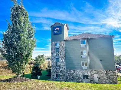 a building with a clock tower on top of it at Suburban Studios Triadelphia - Wheeling at The Highlands in Triadelphia