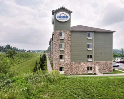 a hotel on a hill with a clock tower at Suburban Studios Triadelphia - Wheeling at The Highlands in Triadelphia