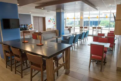a dining room with a table and chairs at Holiday Inn Express & Suites - Fort Wayne North by IHG in Sunnybrook Acres