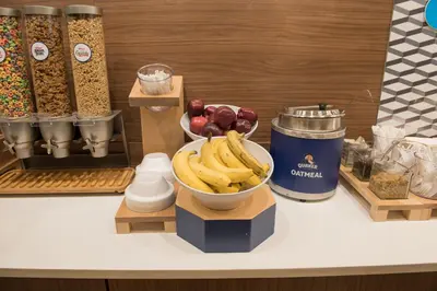 a counter with a bowl of bananas and other ingredients at Holiday Inn Express & Suites - Fort Wayne North by IHG in Sunnybrook Acres