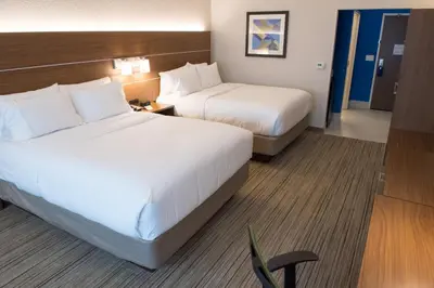 a hotel room with two beds and a desk at Holiday Inn Express & Suites - Fort Wayne North by IHG in Sunnybrook Acres