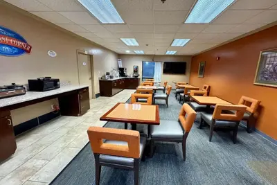 a waiting room with tables and chairs in a restaurant at Baymont by Wyndham Mason in Mason