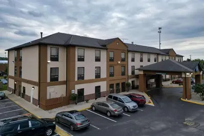 a large building with cars parked in a parking lot at Baymont by Wyndham Mason in Mason