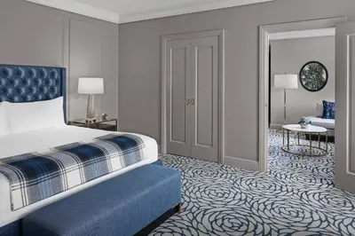 a bedroom with a bed and a room with a couch at The Lytle Park Hotel, Autograph Collection in Cincinnati