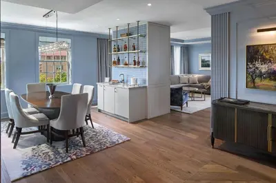 a dining room and living room with a table and chairs at The Lytle Park Hotel, Autograph Collection in Cincinnati
