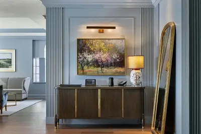 a living room with a desk and a painting on the wall at The Lytle Park Hotel, Autograph Collection in Cincinnati