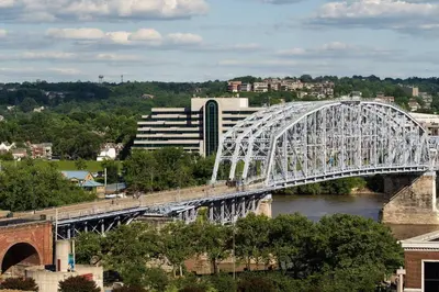 a bridge over a river with a train on it at The Lytle Park Hotel, Autograph Collection in Cincinnati