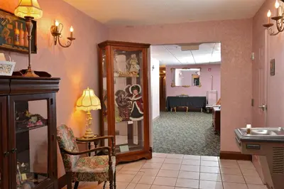 a living room with a hallway with a dining room at OurGuest Inn & Suites Downtown Port Clinton in Port Clinton