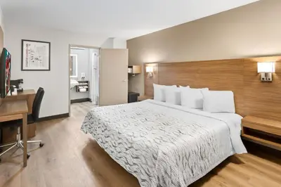 a hotel room with a large bed and a desk at Red Roof Inn PLUS+ Columbus-Ohio State University OSU in Columbus