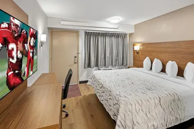 a hotel room with a bed and a tv at Red Roof Inn PLUS+ Columbus-Ohio State University OSU in Columbus