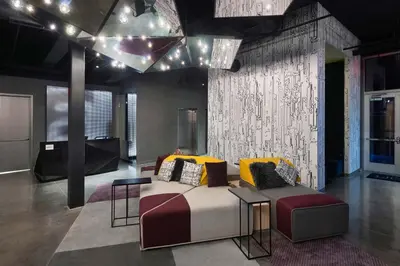a living room with a couch and a table at Aloft Cincinnati West Chester in West Chester