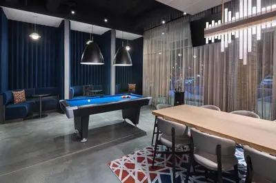 a room with a pool table and a ping pong table at Aloft Cincinnati West Chester in West Chester