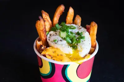 a cup of fries with an egg and french fries at Aloft Cincinnati West Chester in West Chester