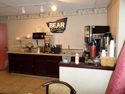 a bar in a restaurant with a coffee shop at Travelodge by Wyndham Cleveland Lakewood in Lakewood