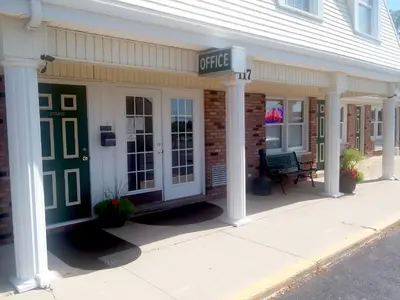 a building with a cafe sign on the front of it at Walton Inn in Willard