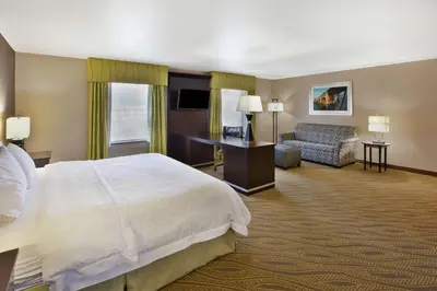 a hotel room with a bed and a couch at Hampton Inn & Suites - Elyria in Elyria