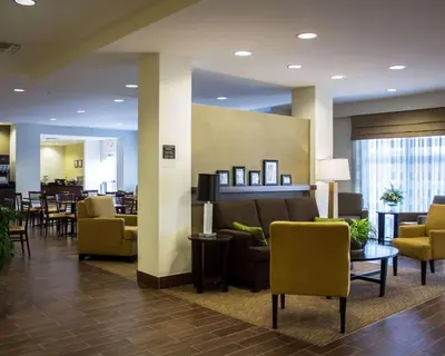 a lobby of a hospital with chairs and tables at Sleep Inn & Suites Moundsville - Wheeling in Moundsville