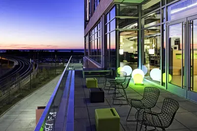 a balcony with chairs and tables on a building at Aloft Cleveland Downtown in Cleveland