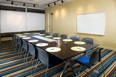 a conference room with a long table and chairs at Aloft Cleveland Downtown in Cleveland