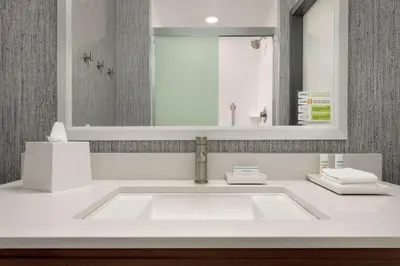 a bathroom with a white sink and a mirror at Home2 Suites By Hilton Dayton/Beavercreek, Oh in Beavercreek