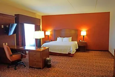 a hotel room with a bed and a desk and a desk at Hampton Inn Waynesburg in Waynesburg